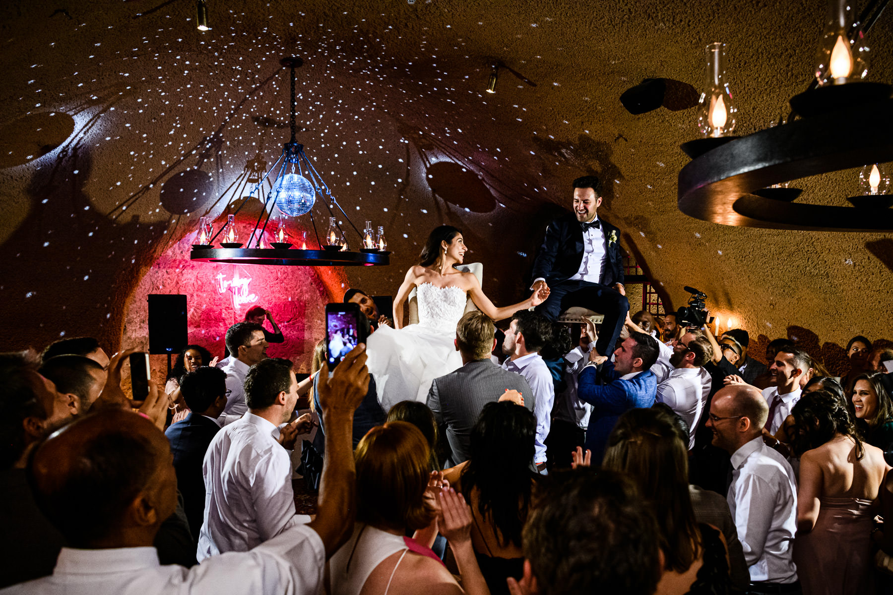 Chair Dance in wine cave at Calistoga Ranch Wedding by Duy Ho