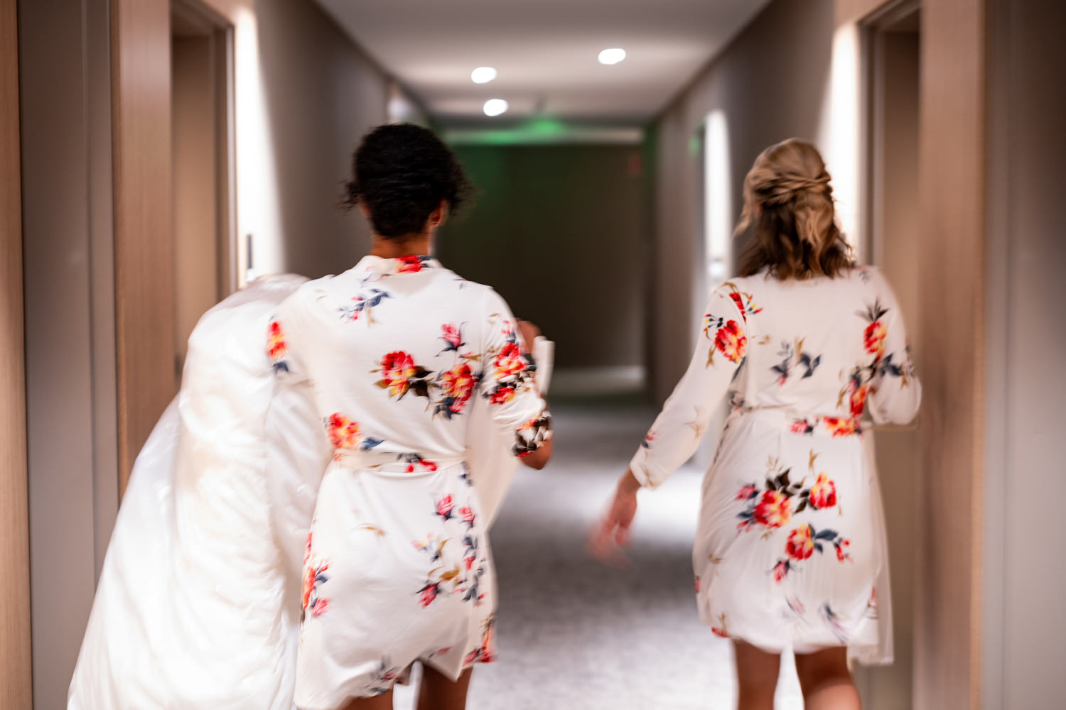 Bride getting ready with bridesmaids in floral robes at AC Hotel San Rafael before Stonetree Estate wedding