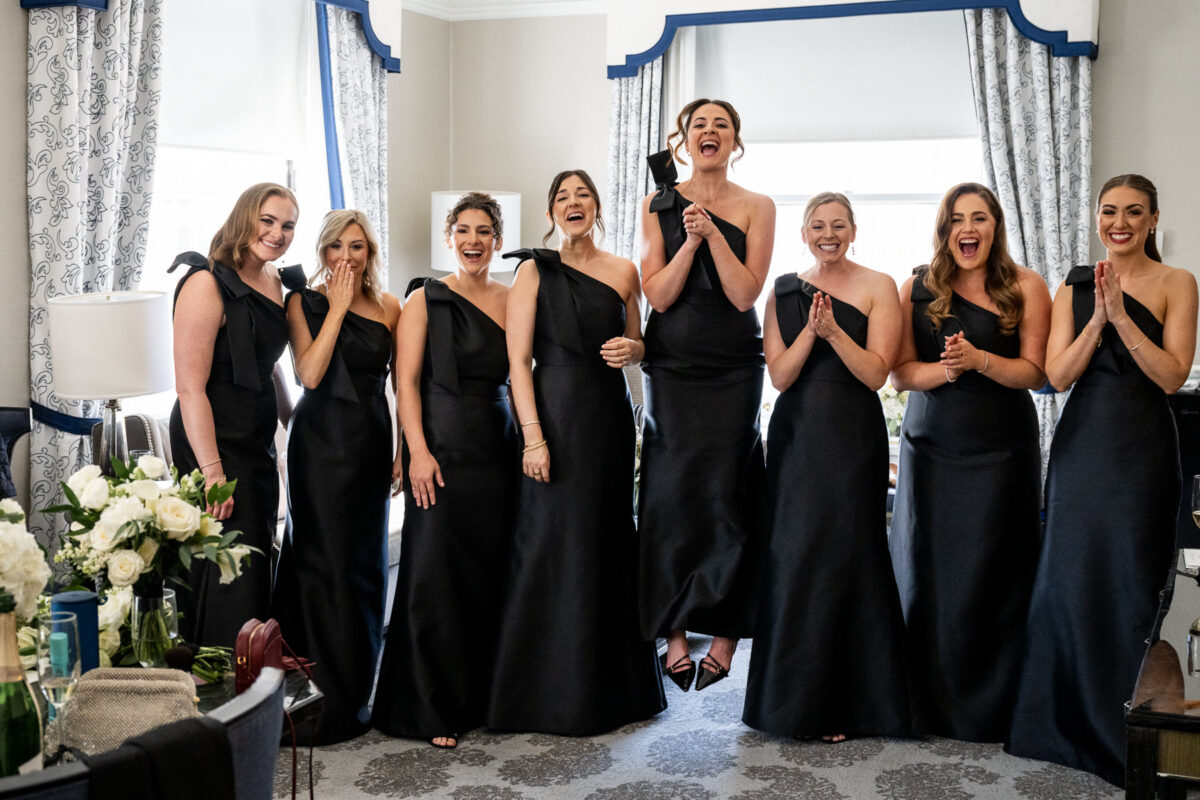 An emotional first look photo of bridesmaids reacting to the bride for their first look. Photo by San Francisco Wedding Photographer Duy Ho