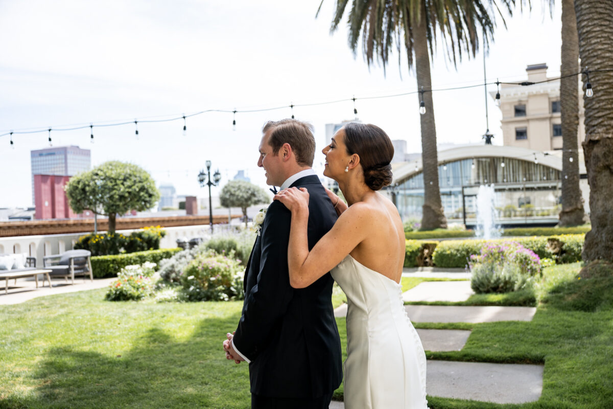 First look photo for the bride and groom on the Fairmont Hotel Rooftop Garden. Photo by San Francisco Wedding Photographer Duy Ho