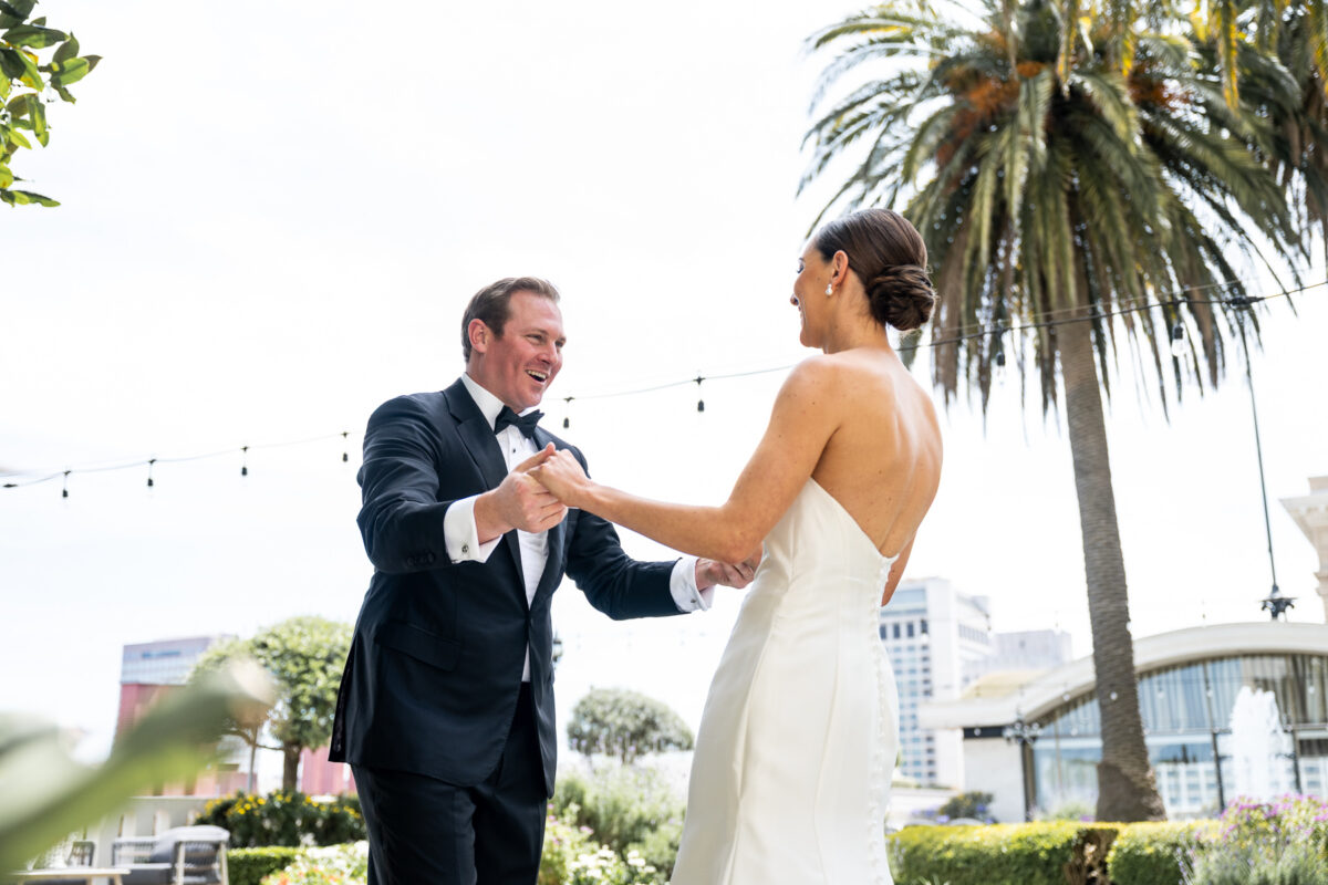 First look photo for the bride and groom on the Fairmont Hotel Rooftop Garden. Photo by San Francisco Wedding Photographer Duy Ho