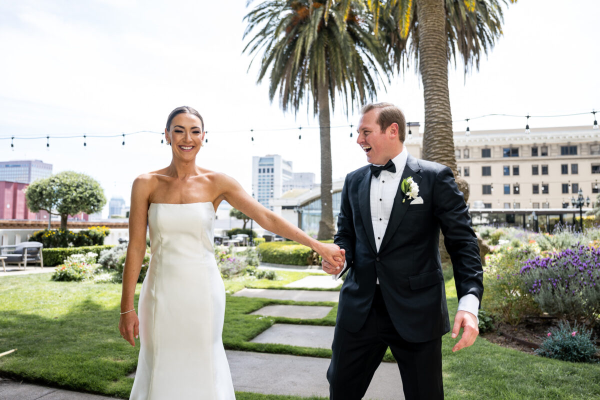 First look photo for the bride and groom on the Fairmont Hotel Rooftop Garden. Photo by San Francisco Wedding Photographer Duy Ho