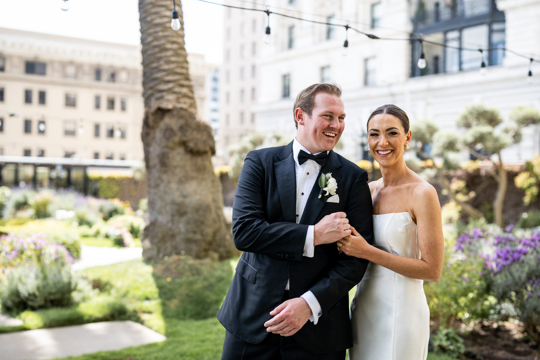 First look photo for the bride and groom on the Fairmont Hotel Rooftop Garden. Photo by San Francisco Wedding Photographer Duy Ho