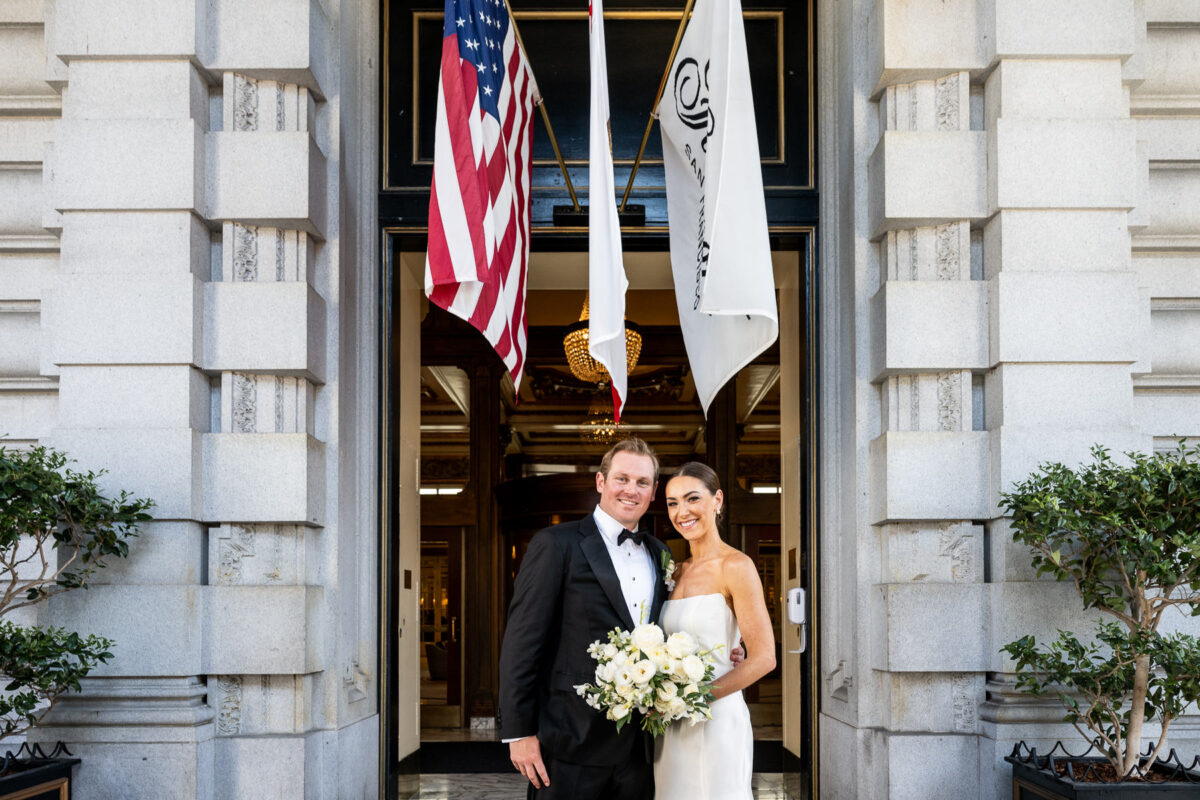 Wedding portrait of a couple at the entrance of the Fairmont San Francisco. Photo by San Francisco Wedding Photographer Duy Ho