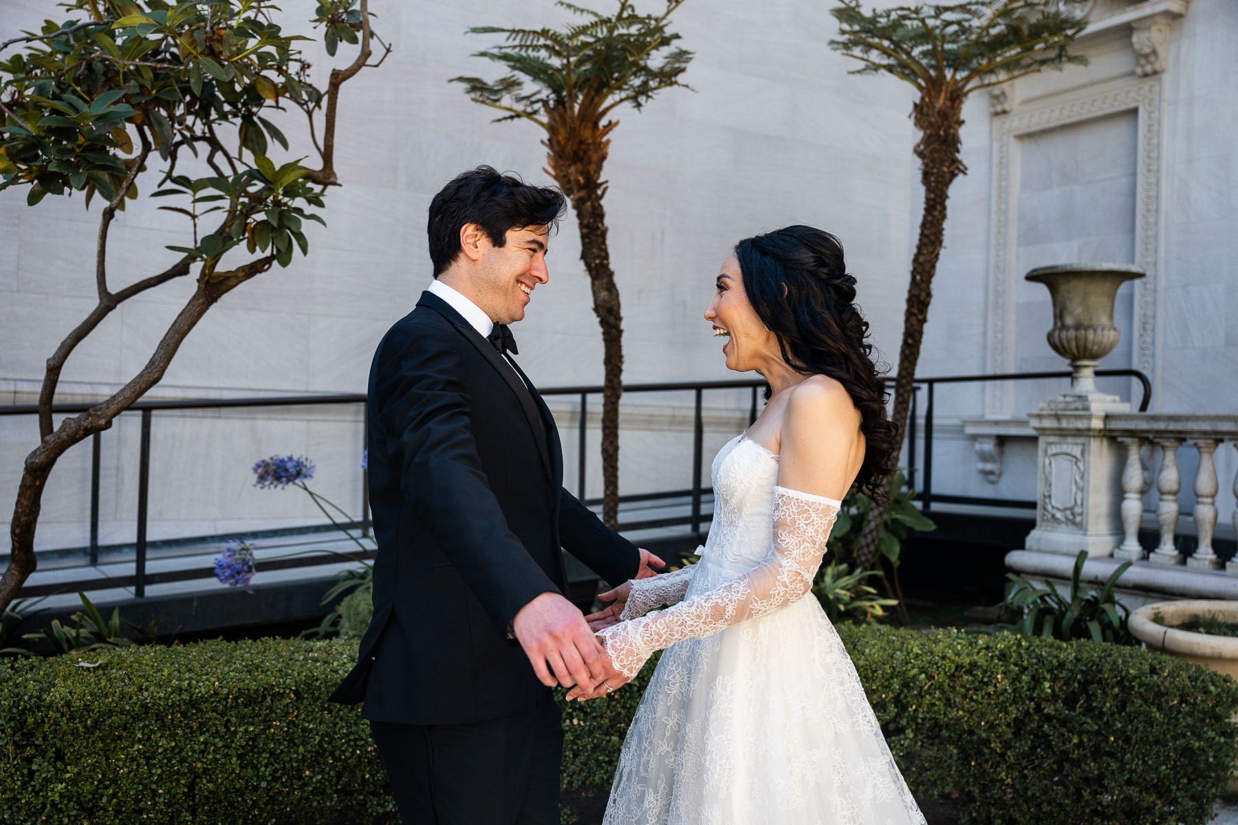 First look moment at Flood Mansion — groom turning to see bride for the first time on mansion entrance steps, San Francisco