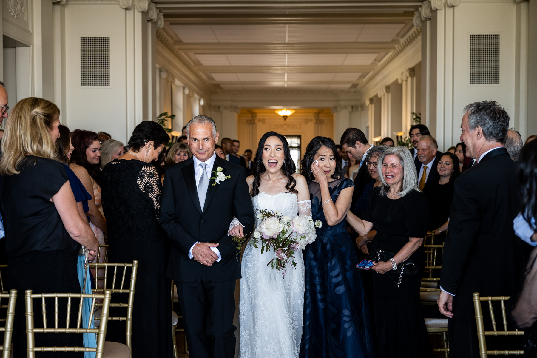 Groom's reaction seeing bride arrive at altar in Flood Mansion Grand Hall, San Francisco mansion wedding ceremony