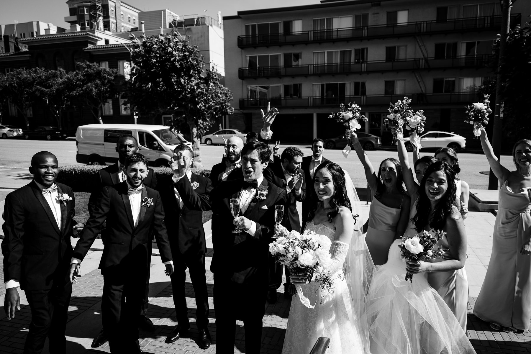 Black and white portrait of bride and groom at Flood Mansion ornate iron gate, San Francisco mansion wedding photography