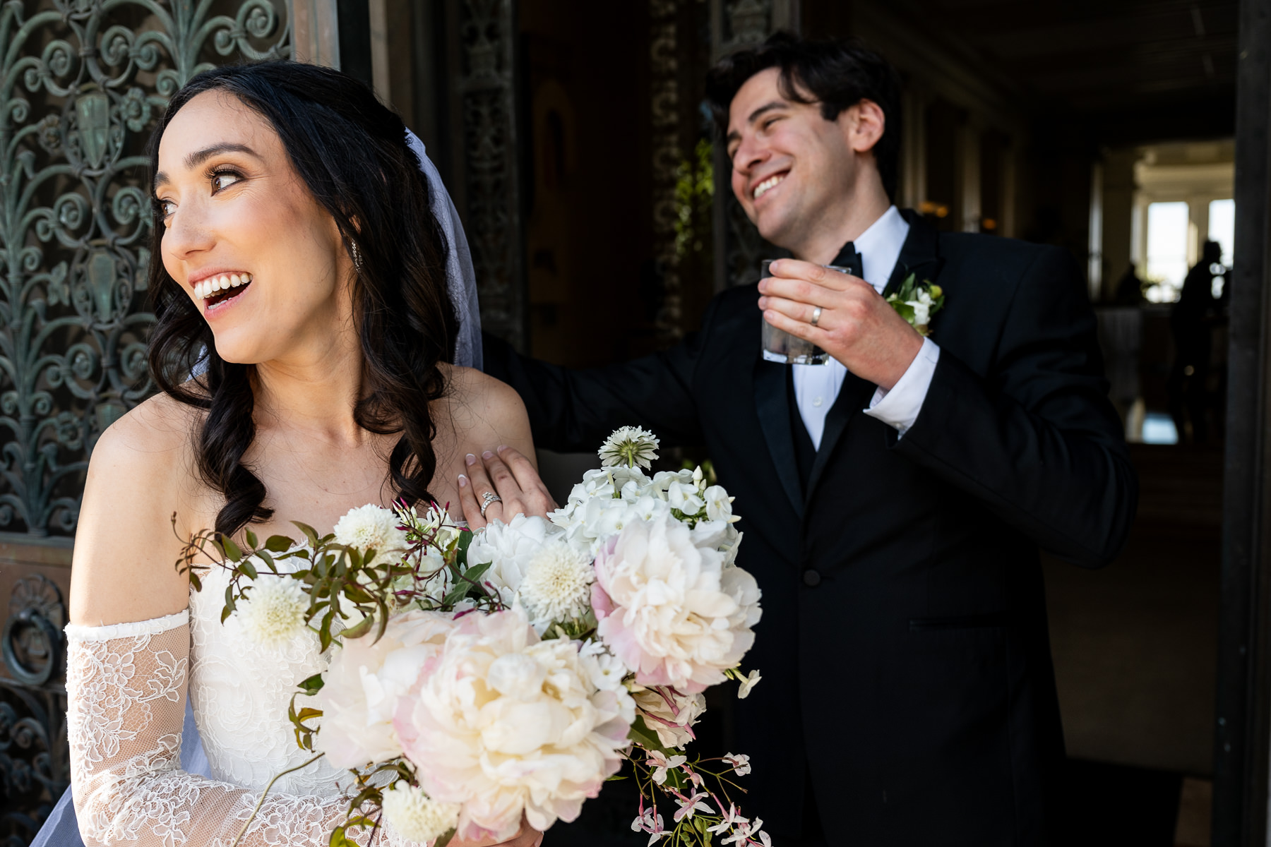 Bride and groom portrait at Flood Mansion arched front doorway, Pacific Heights San Francisco mansion wedding