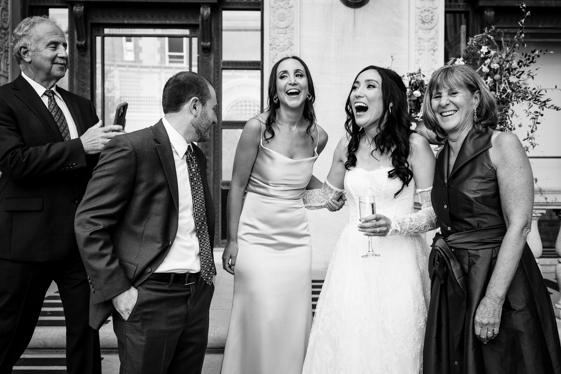 Bride laughing with family during cocktail hour in Flood Mansion courtyard, Pacific Heights San Francisco