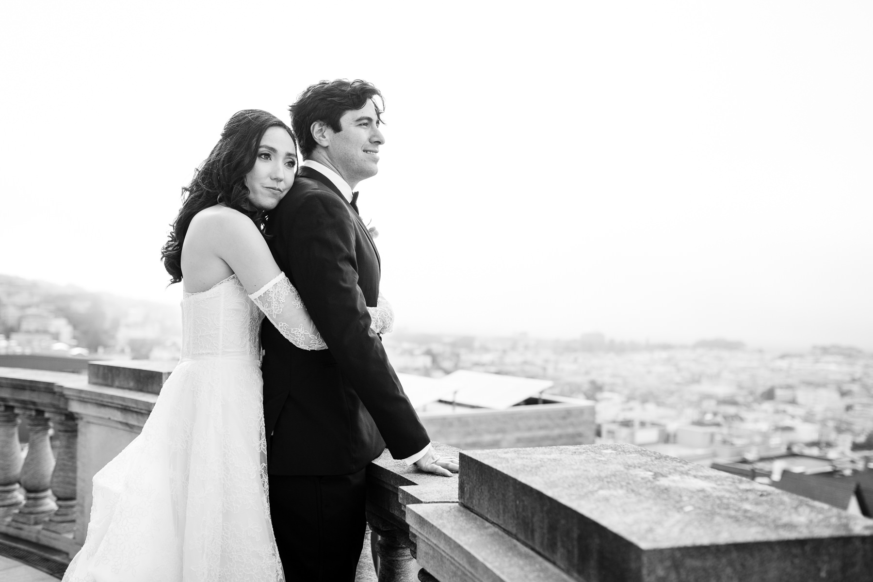 Black and white couple portrait on Flood Mansion rooftop terrace overlooking San Francisco skyline