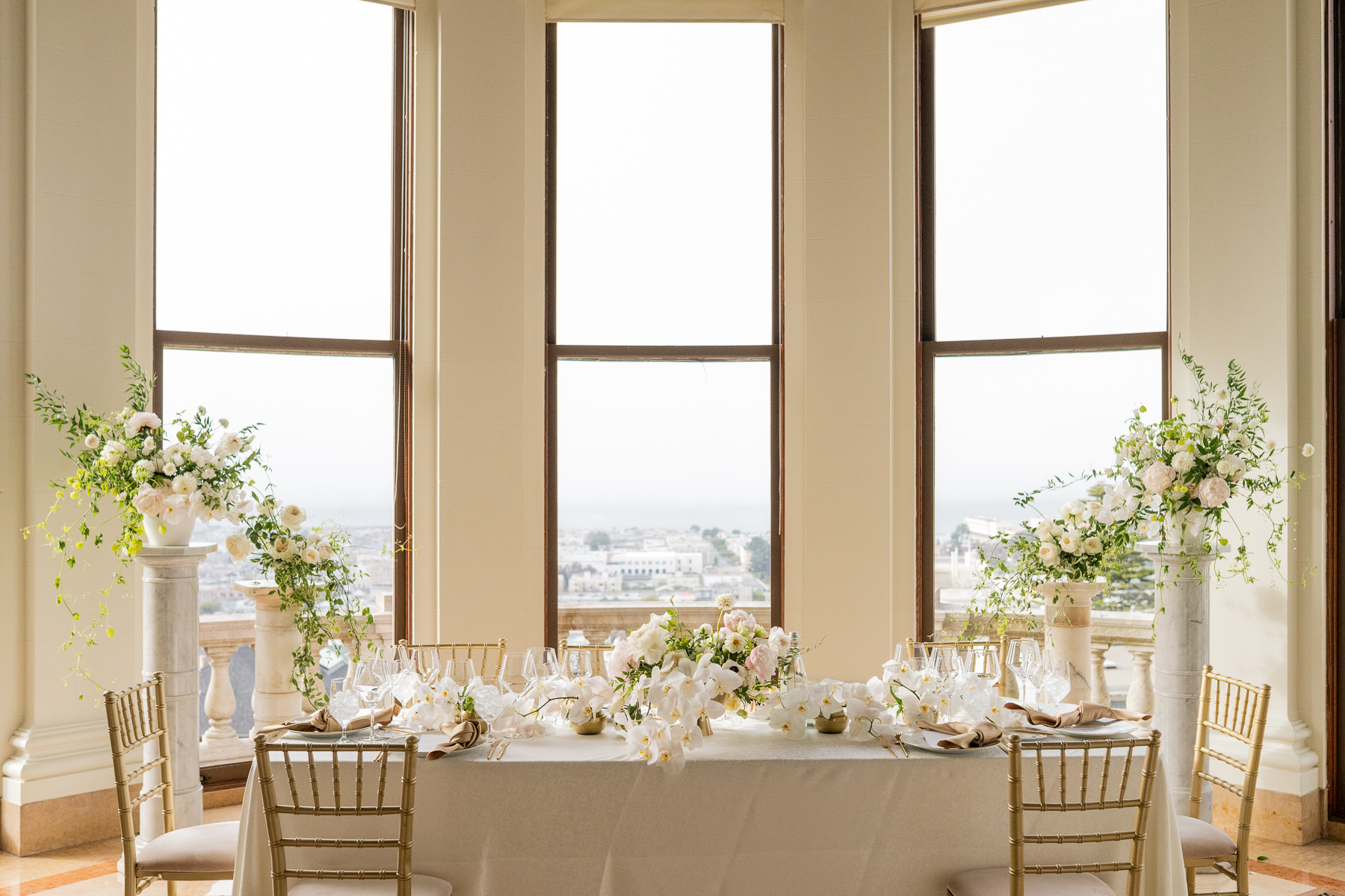 Low white floral centerpiece with orchids at Flood Mansion reception table, San Francisco mansion wedding detail