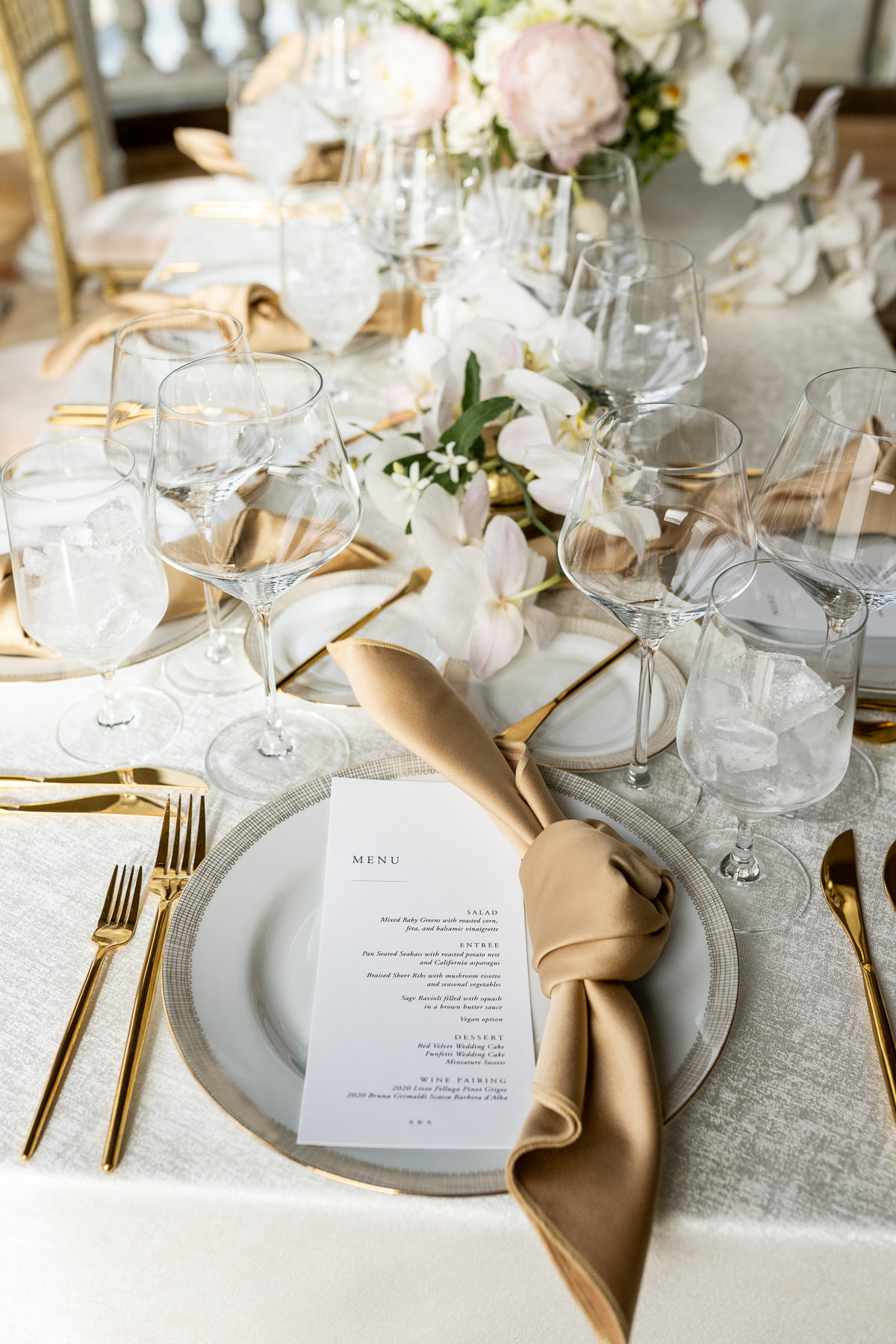Grand Hall reception setup wide shot at Flood Mansion — round tables with gold chiavari chairs and bay windows, San Francisco