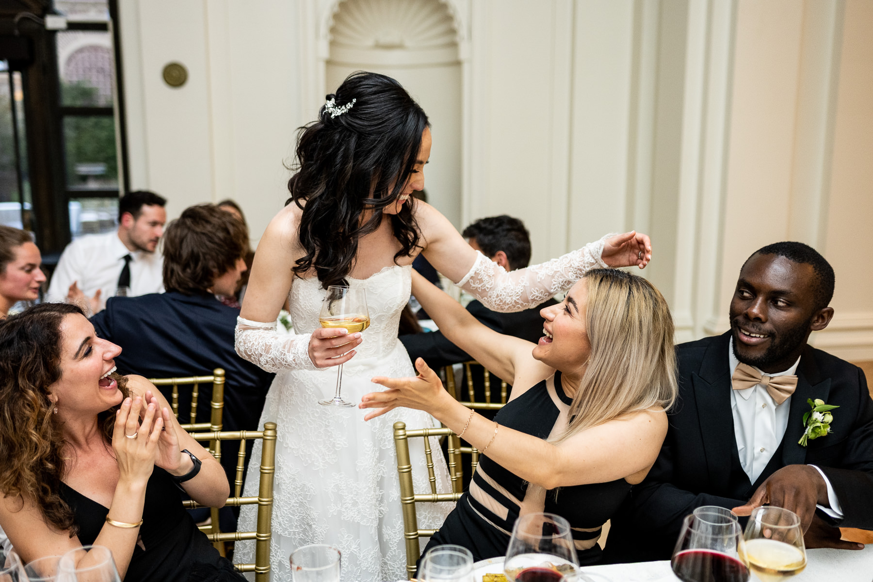 First dance in Flood Mansion Grand Hall — couple on dance floor with guests circled around, warm evening light