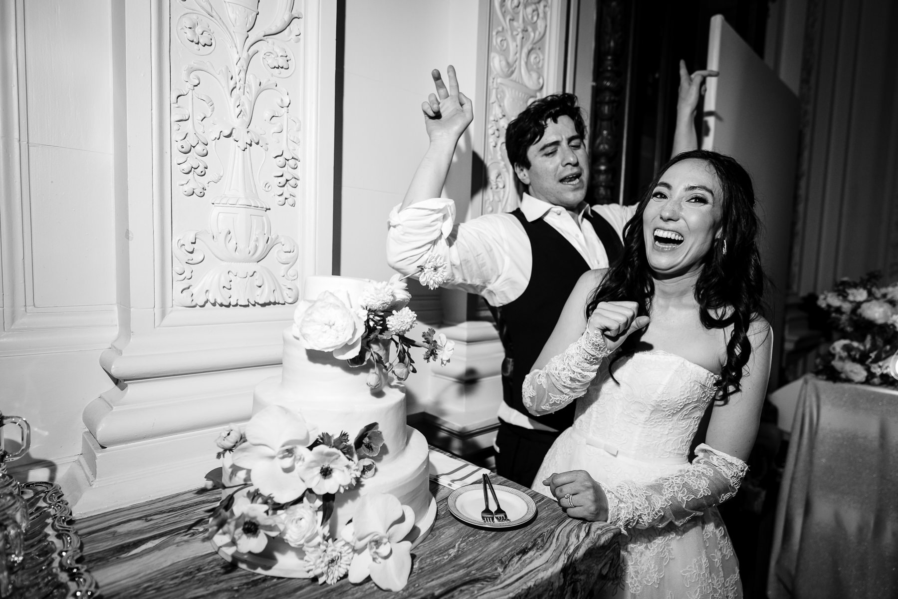 Groom dancing energetically on dance floor with guests at Flood Mansion wedding reception, San Francisco