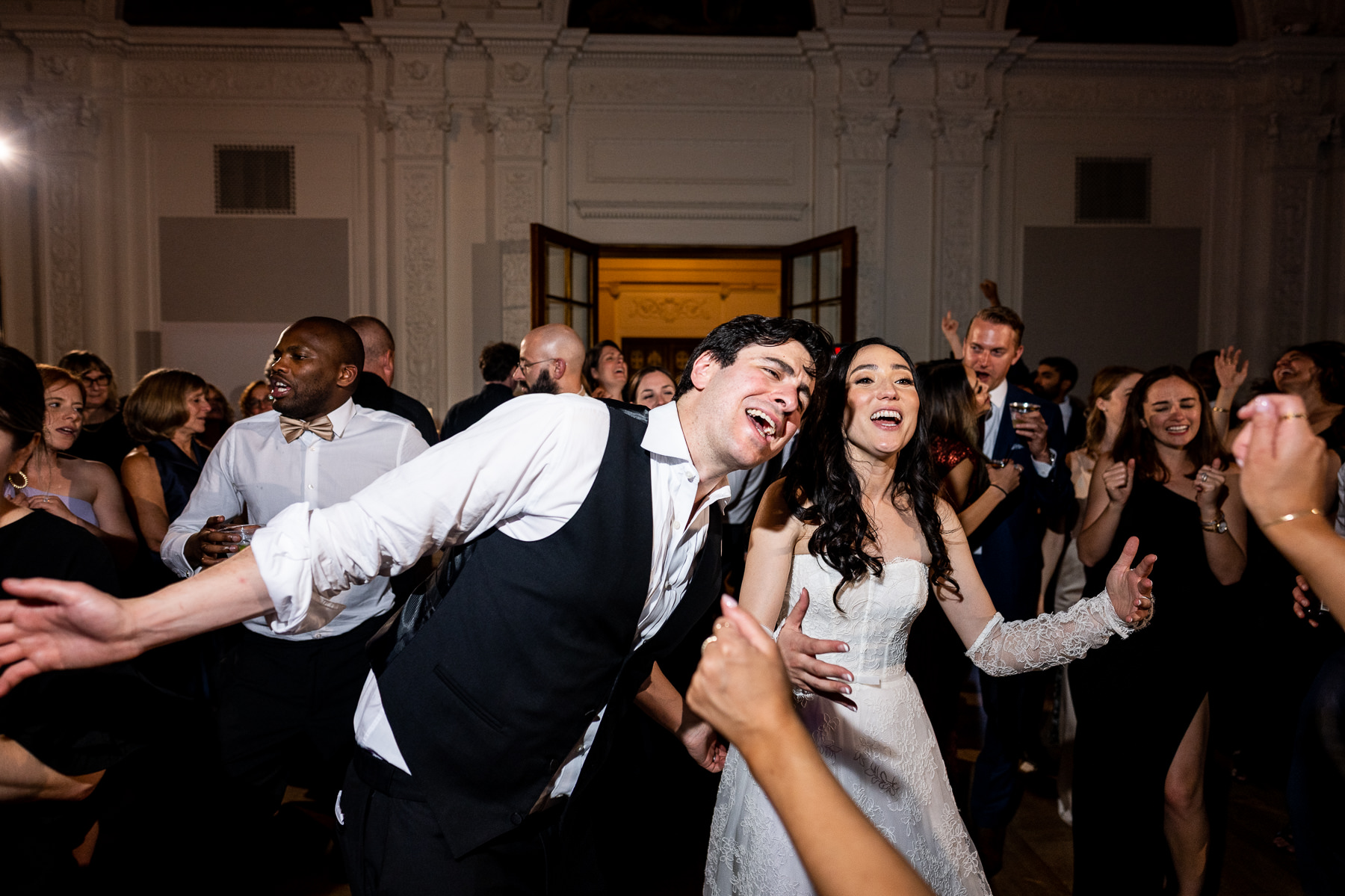 Bride being lifted by guests during celebratory dance in Flood Mansion Grand Hall reception, San Francisco wedding